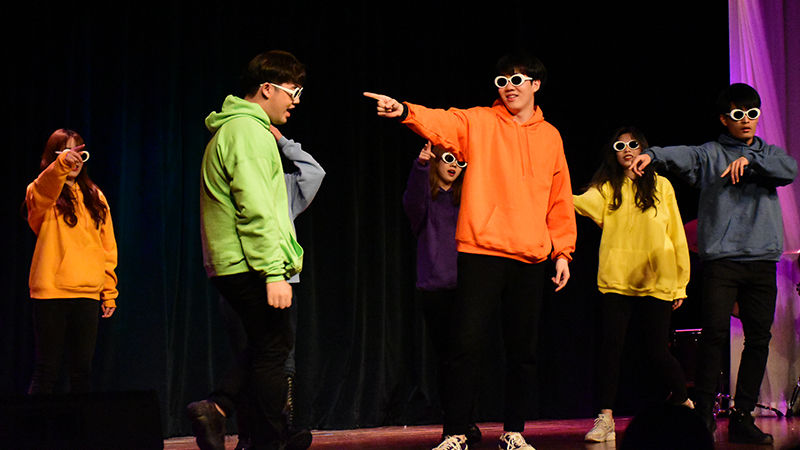 five students on stage