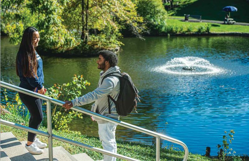 Students talking by pond