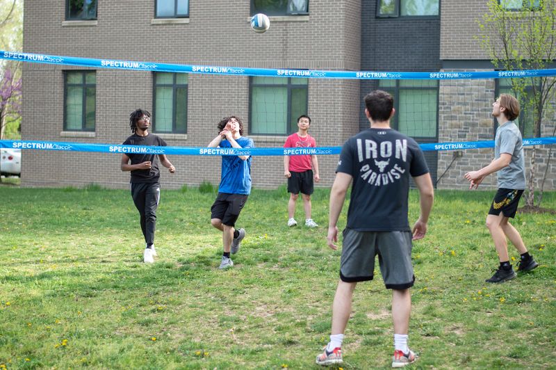 students playing volleyball outside of Lions Gate