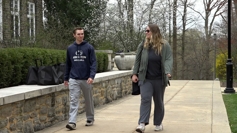 Man and woman walking along concrete path