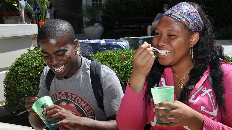 two students eating ice cream and smiling
