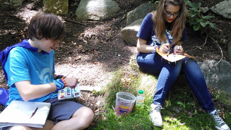 Students drawing outside