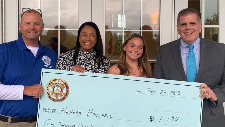 Montgomery County Sheriff's Office Chief Deputy Adam Berry, county Commissioner Jamila Winder, student Hannah Howshall, and Sheriff Sean Kilkenny with Hannah's scholarship check