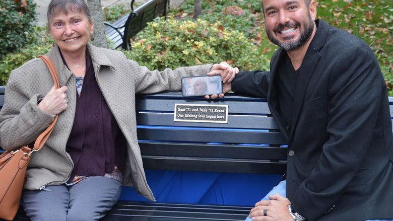 Barb Evans and her son Brett and a bench dedication