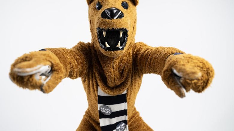 The Nittany Lion mascot points to the camera with both hands