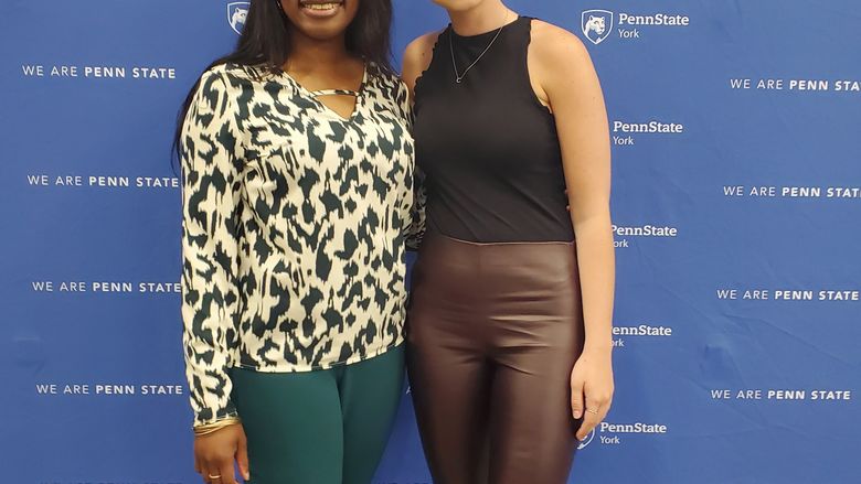 Student and faculty member smiling for photo