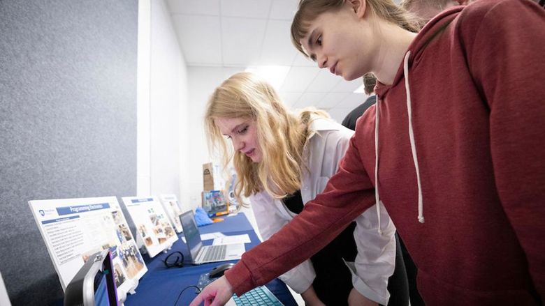 Two people looking at a computer