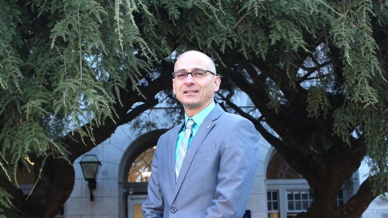 Gary Liquori standing in front of a building