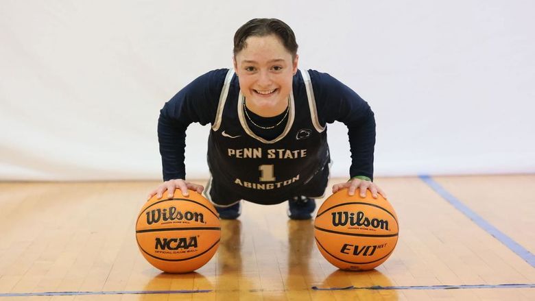 Athlete balancing on two basketballs