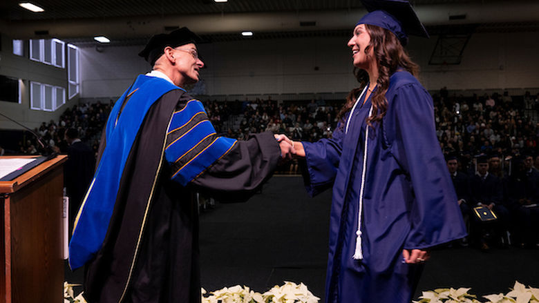 Student shaking chancellors hand at commencement