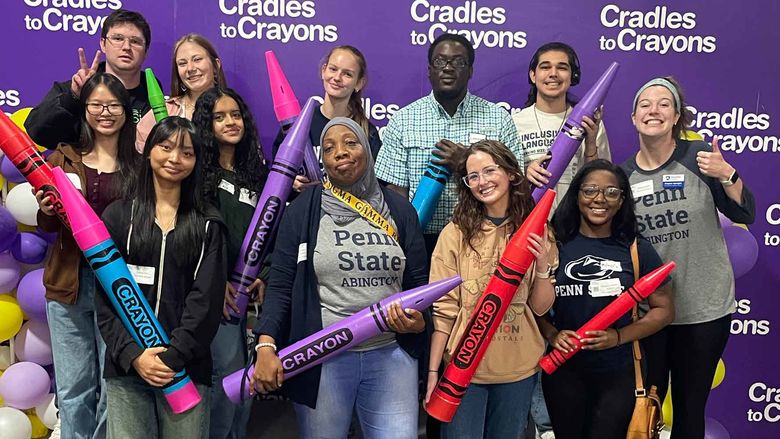 students pose for group photo at Cradles to Crayons