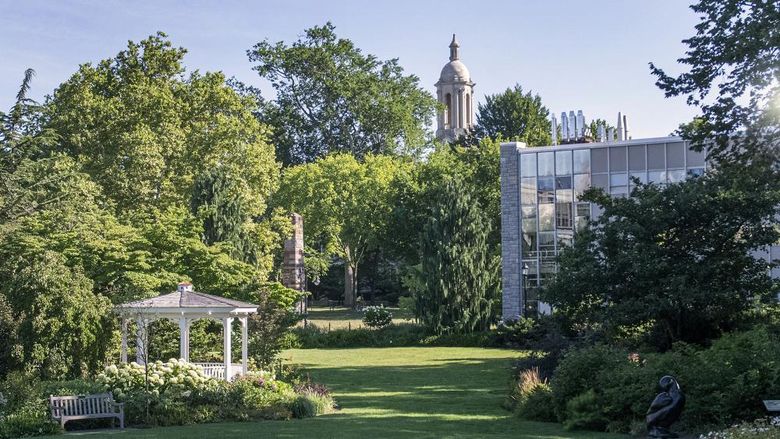 Hintz Family Alumni Center lawn on a sunny day with the Old Main bell tower in the background