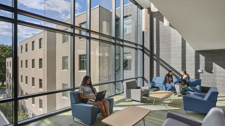 Students working in the student lounge at lions gate