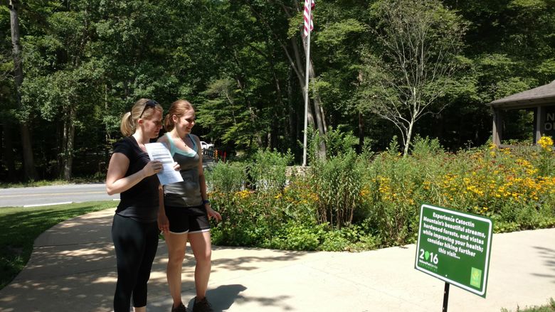 Park Visitors interact with sign