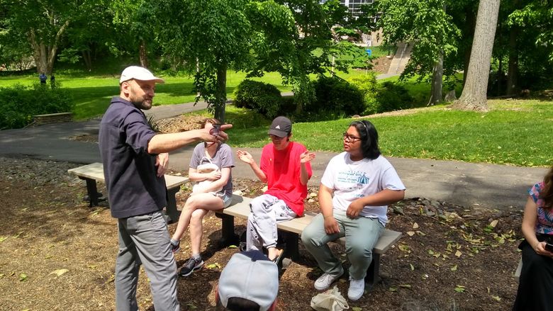 Artist talking to students outside