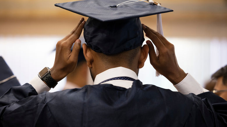 Graduation cap being put on 