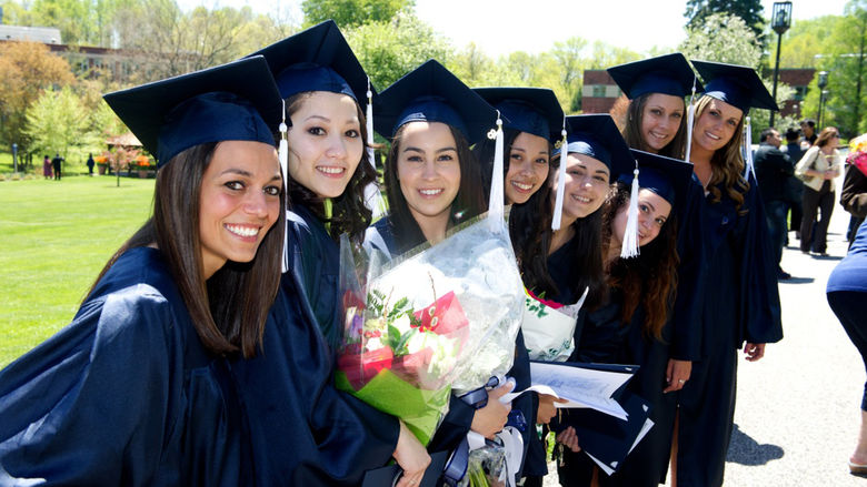 A close-knit group of Penn State Brandywine graduates celebrated in the sunshine on the campus lawn
