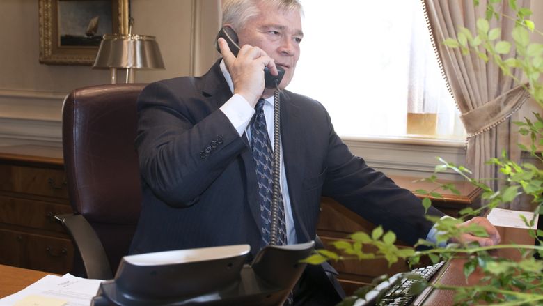 Penn State President Eric Barron on the phone at his desk on May 12.