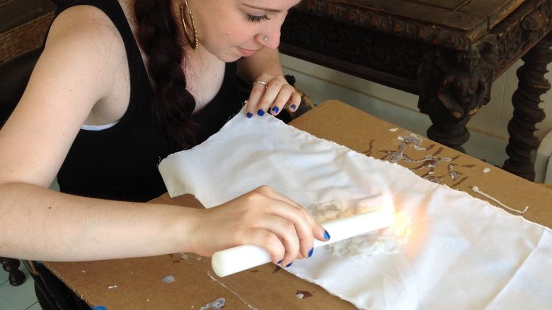 Susan Stanton practices print making at an art residency.