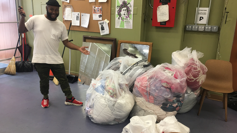 Tate Tippett of Prevention Point Homeless Shelter receives bedding from Penn State Abington's end-of-year recycling drive