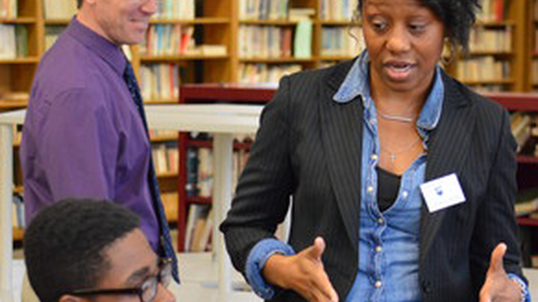 Admissions counselor speaks with high school student