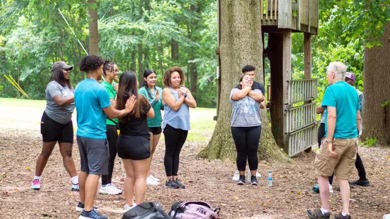 group of students doing trust fall exercise 