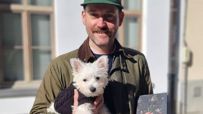 Andrew Bricker with a white dog