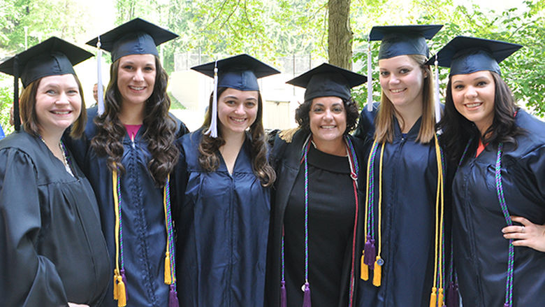 graduates with Ann Mgraduates