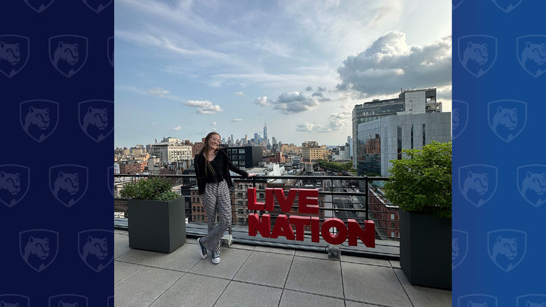 Woman standing on roof with Live Nation sign in red