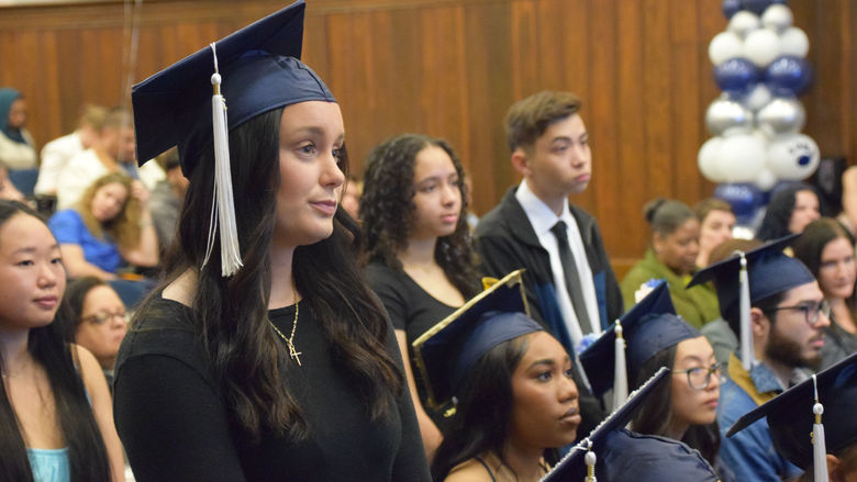 Student standing up during cermony 