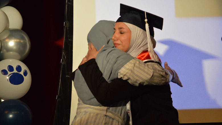 Student and a loved one on stage