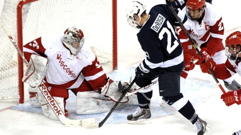 Penn State's Ricky DeRosa takes the puck to the net against Wisconsin