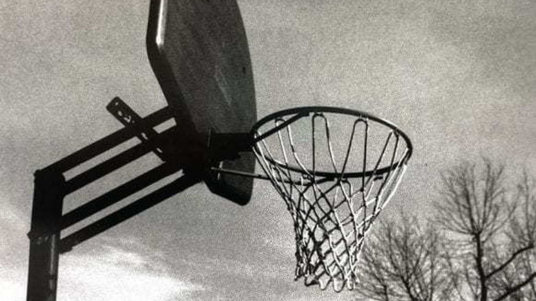 Black and white image of a basketball net