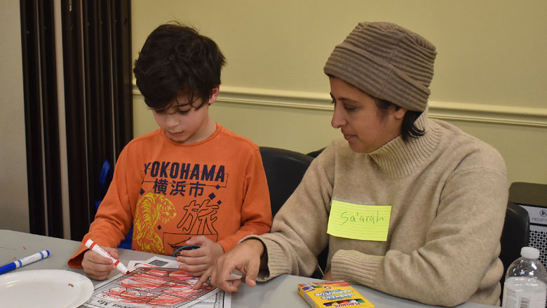 Parent and child completing worksheets
