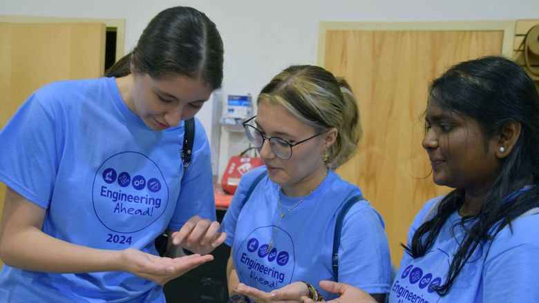 three women students looking at air particle