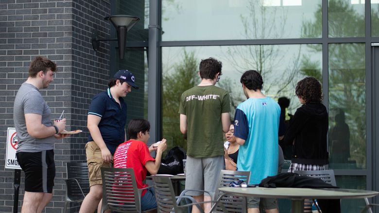 students sitting outside of Lions Gate