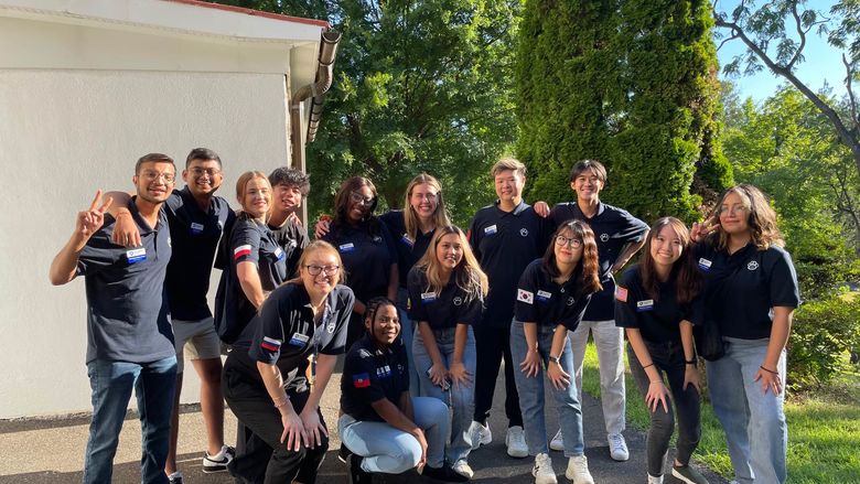 Students standing and smiling in group shot