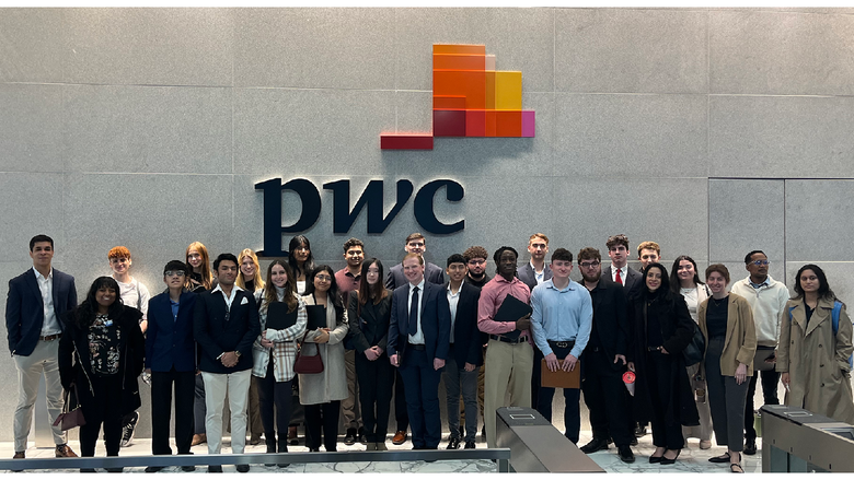Students in front of a sign
