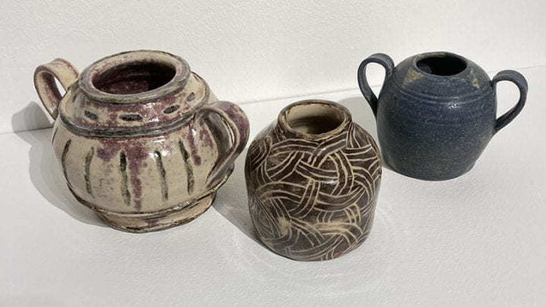 Three ceramic handled pots