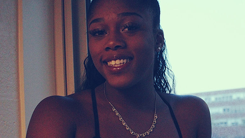 Kay Adetiba stands in front of a window