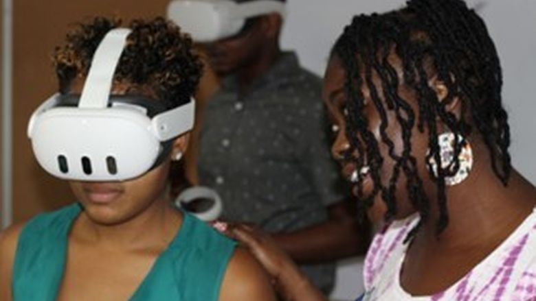 Two people, one in a VR headset