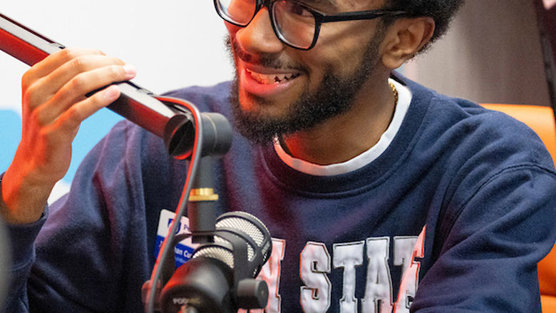 student talking into podcast mic