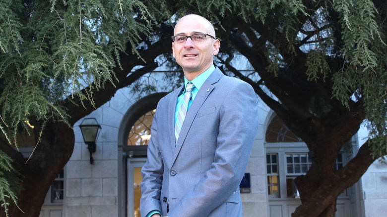 Gary Liquori standing in front of a building