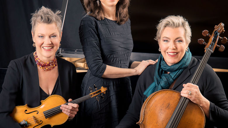 Merion Trio sitting with their instruments smiling 
