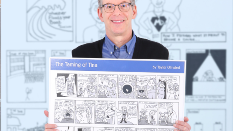 Michael Green holding comic poster