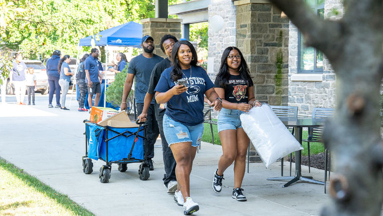Student with luggage moving into dormitory