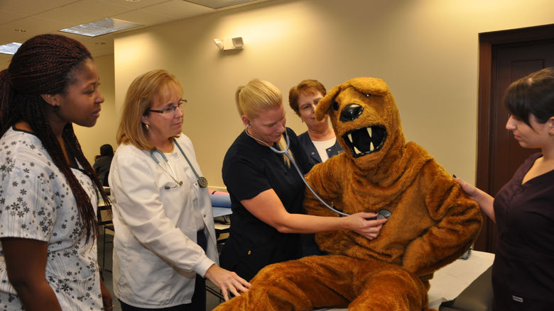 Nittany Lion being examed by nurses