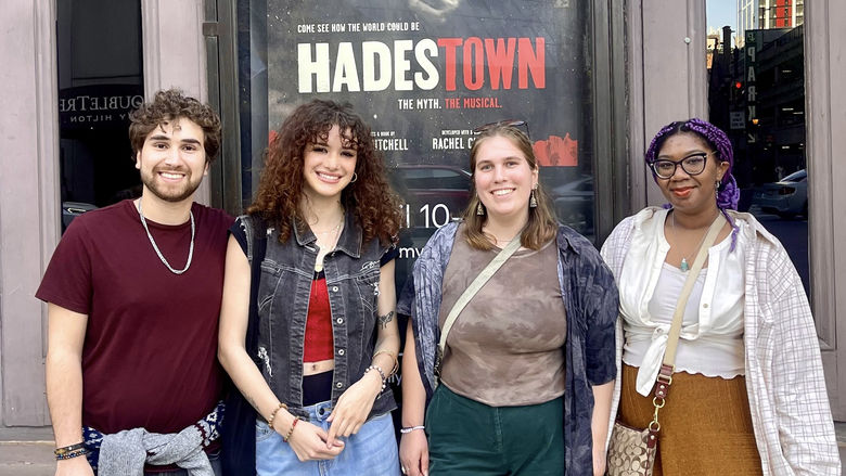 students standing in front of theatre