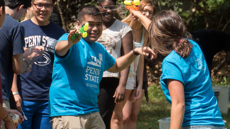 students shooting water guns at eachother