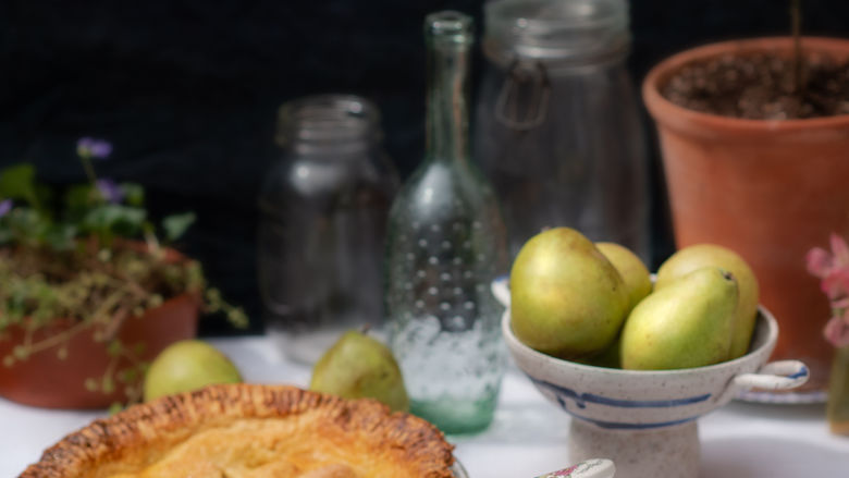 Pear pie with a slice cut on a plate